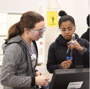 Students conducting an experiment, wearing protective gear